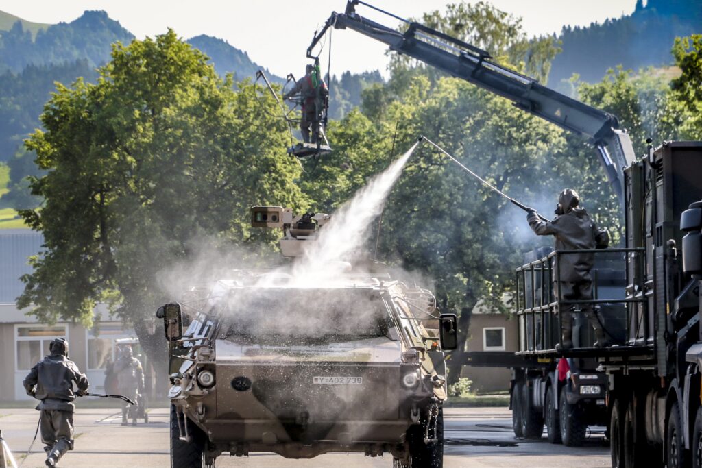 Lehrgangsteilnehmer üben das Dekontaminieren von Fahrzeugen. Foto: Bundeswehr / Michael Lukaszewski