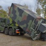 Die beauftragten Standard-Wechselpritschen werden bereits in der Bundeswehr genutzt, hier wird die Wechselpritsche als Ladungsträger für einen Container von einem Lkw abgesetzt.