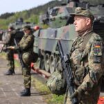 Soldaten vom Heimatschutzregiment 1 bewachen die Verladestelle bei einer Bahnverladung während der Heimatschutzübung National Guardian 2024 im Rahmen der Übungsserie Quadriga 2024.